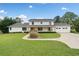 Charming two-story white home with a well-manicured lawn, covered porch, and an attached two-car garage at 1435 Willis Lake Nw Dr, Kennesaw, GA 30152