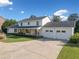 Charming single-Gathering home with a well-manicured lawn, spacious driveway, and inviting front porch with a swing at 1435 Willis Lake Nw Dr, Kennesaw, GA 30152