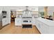 Bright kitchen featuring white cabinets, stainless steel appliances, and a decorative backsplash at 1435 Willis Lake Nw Dr, Kennesaw, GA 30152