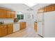 The kitchen features wooden cabinets and white appliances and offers a functional layout at 1435 Willis Lake Nw Dr, Kennesaw, GA 30152