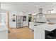 Spacious white kitchen featuring stainless steel appliances, a large island, and open shelving at 1435 Willis Lake Nw Dr, Kennesaw, GA 30152