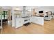 Well-lit kitchen with white cabinets, stainless appliances, decorative backsplash, and open layout to living areas at 1435 Willis Lake Nw Dr, Kennesaw, GA 30152