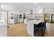 Bright, open kitchen with white cabinets, stainless steel appliances, large island, and hardwood floors at 1435 Willis Lake Nw Dr, Kennesaw, GA 30152