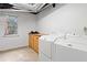 The laundry room features side-by-side washer and dryer with natural light streaming in from a window at 1435 Willis Lake Nw Dr, Kennesaw, GA 30152