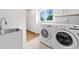 Functional laundry room with a utility sink, a window and modern appliances at 1435 Willis Lake Nw Dr, Kennesaw, GA 30152