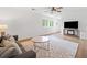 Bright living room with hardwood floors, a comfortable sofa, and a decorative rug at 1435 Willis Lake Nw Dr, Kennesaw, GA 30152