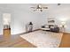 Cozy living room with hardwood floors, neutral-toned furniture, and a decorative rug at 1435 Willis Lake Nw Dr, Kennesaw, GA 30152