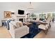 Bright living room with hardwood floors, fireplace, modern lighting, and stylish furnishings at 1435 Willis Lake Nw Dr, Kennesaw, GA 30152