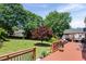 An expansive backyard features a large wooden deck and mature trees providing ample shade and privacy at 3331 Lockwood Sw Ct, Lilburn, GA 30047