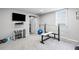Finished basement workout room with fitness equipment and tv at 3331 Lockwood Sw Ct, Lilburn, GA 30047