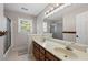 Bathroom featuring double sinks, shower with glass door, and light wood cabinets at 3331 Lockwood Sw Ct, Lilburn, GA 30047