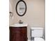 Bathroom with a decorative sink cabinet, mirror and toilet at 3331 Lockwood Sw Ct, Lilburn, GA 30047