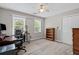 Bedroom featuring a ceiling fan, carpet, and dual windows for natural light at 3331 Lockwood Sw Ct, Lilburn, GA 30047