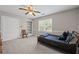 Bright bedroom with a ceiling fan, closet, and shelving unit at 3331 Lockwood Sw Ct, Lilburn, GA 30047