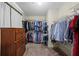 Walk-in closet featuring ample storage space and well-organized clothing racks at 3331 Lockwood Sw Ct, Lilburn, GA 30047