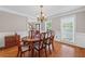 Formal dining room with hardwood floors, traditional chandelier, and wainscoting at 3331 Lockwood Sw Ct, Lilburn, GA 30047