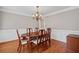 Dining room with hardwood flooring, traditional furniture, and neutral paint at 3331 Lockwood Sw Ct, Lilburn, GA 30047