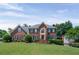 Traditional brick home with a manicured lawn and lush landscaping, exuding classic charm and curb appeal at 3331 Lockwood Sw Ct, Lilburn, GA 30047