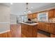 Well-appointed kitchen featuring a central island, granite countertops, and wood cabinets for efficient meal preparation at 3331 Lockwood Sw Ct, Lilburn, GA 30047