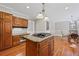 Traditional kitchen with granite counters, wood cabinets, hardwood floors, and center island with gas cooktop at 3331 Lockwood Sw Ct, Lilburn, GA 30047