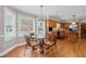 Eat-in kitchen area with bay window, hardwood floors, and traditional cabinetry at 3331 Lockwood Sw Ct, Lilburn, GA 30047