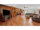 Cozy living room featuring wood paneling, built-in shelving, a fireplace, and ample seating space for Gathering gatherings at 3331 Lockwood Sw Ct, Lilburn, GA 30047