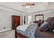 Bedroom featuring neutral carpeting, ceiling fan, and traditional furniture at 3331 Lockwood Sw Ct, Lilburn, GA 30047