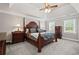 Main bedroom with tray ceiling, neutral carpet, and traditional furniture at 3331 Lockwood Sw Ct, Lilburn, GA 30047
