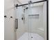 Modern bathroom with tile shower, sleek black fixtures, and built-in niche at 3331 Lockwood Sw Ct, Lilburn, GA 30047