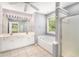 Spacious bathroom featuring double vanity, soaking tub, walk-in shower, and tiled floor at 3471 Chastain Glen Ne Ln, Marietta, GA 30066