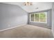Bright bedroom with neutral carpet, vaulted ceiling, large window, and ceiling fan at 3471 Chastain Glen Ne Ln, Marietta, GA 30066