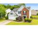 Two-story home featuring light blue siding, brick accents, a manicured lawn, and a two-car garage at 3471 Chastain Glen Ne Ln, Marietta, GA 30066