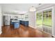 Bright kitchen features stainless steel appliances, blue and white cabinets, island, and sliding door to back yard at 3471 Chastain Glen Ne Ln, Marietta, GA 30066