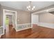 Open-concept living room with hardwood floors and wainscoting, with entryways into other rooms at 3471 Chastain Glen Ne Ln, Marietta, GA 30066
