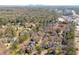 An aerial view of a residential community with mature trees and a city skyline in the background at 45 Paces West Nw Dr, Atlanta, GA 30327