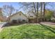Spacious backyard with lush lawn, mature trees, and a view of the home with a detached garage at 45 Paces West Nw Dr, Atlanta, GA 30327