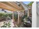 Welcoming backyard brick patio with covered seating and dining areas nestled amid mature plants at 45 Paces West Nw Dr, Atlanta, GA 30327