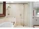 Bathroom featuring a glass-enclosed shower, soaking tub, and elegant fixtures at 45 Paces West Nw Dr, Atlanta, GA 30327