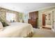 Bright bedroom with floral accents, large bed, and a view into the bathroom at 45 Paces West Nw Dr, Atlanta, GA 30327