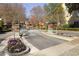 Gated community entrance with brick pillars and manicured landscaping at 45 Paces West Nw Dr, Atlanta, GA 30327