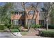 Charming brick home with manicured landscaping, lush greenery, and inviting curb appeal at 45 Paces West Nw Dr, Atlanta, GA 30327