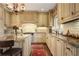 Charming kitchen featuring custom cabinetry, granite countertops, and a lovely chandelier at 45 Paces West Nw Dr, Atlanta, GA 30327