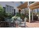 Inviting brick patio with outdoor dining and a covered seating area surrounded by mature greenery at 45 Paces West Nw Dr, Atlanta, GA 30327