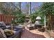 Charming brick patio featuring an outdoor fireplace, cozy seating, and well-maintained landscaping at 45 Paces West Nw Dr, Atlanta, GA 30327