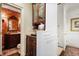 Powder room decorated with a floral wallpaper and dark-stained cabinet sink at 45 Paces West Nw Dr, Atlanta, GA 30327