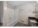 Bathroom featuring a tub with tiled walls and a black fixture towel rack at 4701 Riverwood Cir, Decatur, GA 30035