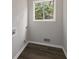 Bright laundry room featuring wood-look floors and a window with a view at 4701 Riverwood Cir, Decatur, GA 30035