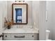 Elegant powder room featuring a marble countertop vanity and stylish framed mirror at 584 Bismark Ne Rd, Atlanta, GA 30324
