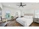 Bright bedroom with hardwood floors, a ceiling fan, and doors to balcony at 584 Bismark Ne Rd, Atlanta, GA 30324