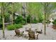 Community courtyard with Adirondack chairs and tables arranged in a gravel setting with trees and landscaping at 584 Bismark Ne Rd, Atlanta, GA 30324